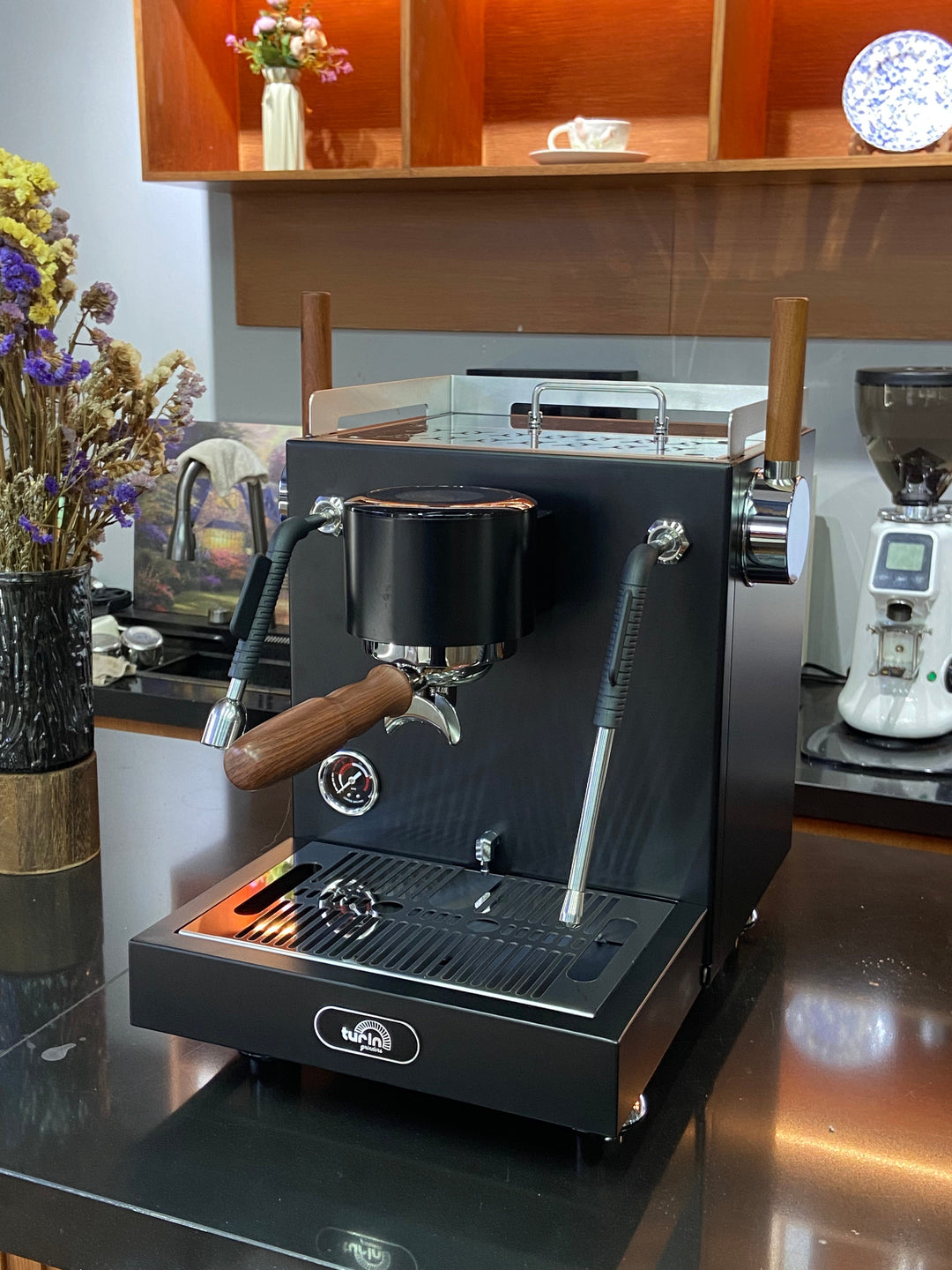 Turin MC3 espresso machine — black machine, angled counter view