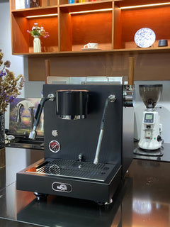Turin MC3 espresso machine — black machine beside grinder