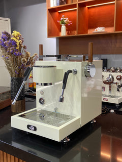 Turin MC3 espresso machine — light-finish machine, angled counter view