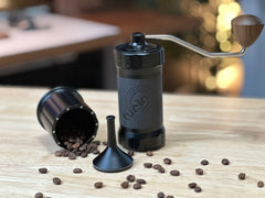 Turin H40 V2 — grinder beside cup spilling coffee beans